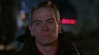 Movie still from “The Fugitive” (1993), directed by Andrew Davis – A person wearing a black jacket; Close Up shot, Low angle