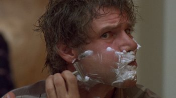 Movie still from “The Fugitive” (1993), directed by Andrew Davis – A person with a shaving foam on his face; Close Up shot, Low angle