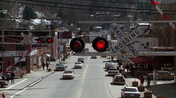 Movie still from “The Fugitive” (1993), directed by Andrew Davis – A street scene with cars driving down the road; Extreme Wide shot, High angle