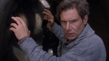 Movie still from “The Fugitive” (1993), directed by Andrew Davis – A person holding something in his hand; Close Up shot, Over the shoulder angle