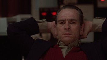 Movie still from “The Fugitive” (1993), directed by Andrew Davis – A person with his hand on his head; Close Up shot, Low angle