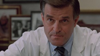 Movie still from “The Fugitive” (1993), directed by Andrew Davis – A person wearing a lab coat; Close Up shot, Low angle