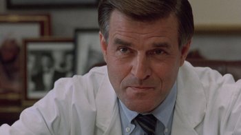 Movie still from “The Fugitive” (1993), directed by Andrew Davis – A person wearing a lab coat; Close Up shot, Low angle