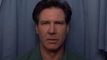 Movie still from “The Fugitive” (1993), directed by Andrew Davis – A person wearing a green shirt; Close Up shot, Low angle