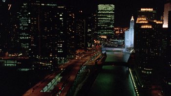 Movie still from “The Fugitive” (1993), directed by Andrew Davis – A view of a city at night from a bridge; Extreme Wide shot, High angle