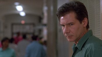 Movie still from “The Fugitive” (1993), directed by Andrew Davis – A person wearing a green shirt; Close Up shot, Low angle