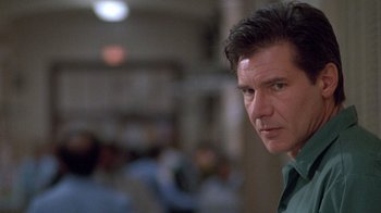 Movie still from “The Fugitive” (1993), directed by Andrew Davis – A person wearing a green shirt; Close Up shot, Over the shoulder angle