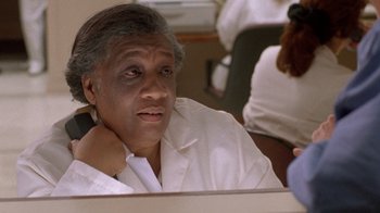 Movie still from “The Fugitive” (1993), directed by Andrew Davis – An older man sitting in front of a mirror; Close Up shot, Low angle