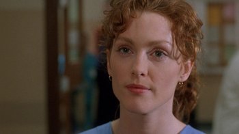 Movie still from “The Fugitive” (1993), directed by Andrew Davis – A person with curly red hair; Close Up shot, Over the shoulder angle