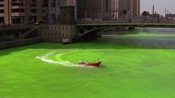 Movie still from “The Fugitive” (1993), directed by Andrew Davis – Three people in a boat in a body of green water; Extreme Wide shot, High angle