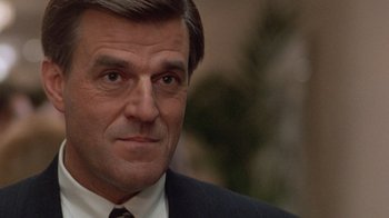 Movie still from “The Fugitive” (1993), directed by Andrew Davis – A person wearing a suit and tie; Close Up shot, Low angle