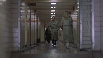 Movie still from “The Fugitive” (1993), directed by Andrew Davis – A man and a woman are walking down a hallway; Wide shot, Low angle