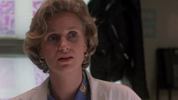 Movie still from “The Fugitive” (1993), directed by Andrew Davis – A person wearing a lab coat; Close Up shot, Low angle
