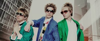 Movie still from “Popstar: Never Stop Never Stopping” (2016), directed by Akiva Schaffer – Two young men wearing sunglasses posing for a picture; Close Up shot, Low angle