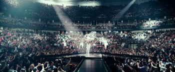 Movie still from “Popstar: Never Stop Never Stopping” (2016), directed by Akiva Schaffer – A crowd of people watching a man on a stage; Extreme Wide shot, High angle