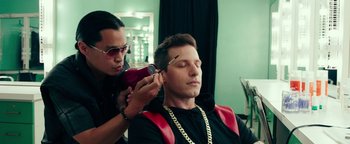 Movie still from “Popstar: Never Stop Never Stopping” (2016), directed by Akiva Schaffer – A man getting his hair cut by a stylist; Medium shot, Over the shoulder angle