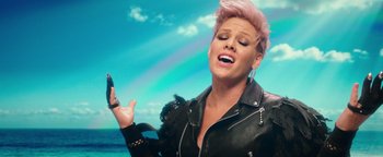 Movie still from “Popstar: Never Stop Never Stopping” (2016), directed by Akiva Schaffer – A woman with pink hair is holding a cell phone; Close Up shot, Low angle