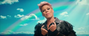 Movie still from “Popstar: Never Stop Never Stopping” (2016), directed by Akiva Schaffer – A woman with pink hair is posing for a picture; Close Up shot, Low angle