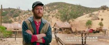 Movie still from “Popstar: Never Stop Never Stopping” (2016), directed by Akiva Schaffer – A man standing in front of an old barn; Medium shot, Over the shoulder angle