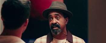 Movie still from “Popstar: Never Stop Never Stopping” (2016), directed by Akiva Schaffer – A person wearing a hat; Close Up shot, Over the shoulder angle