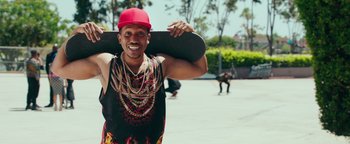 Movie still from “Popstar: Never Stop Never Stopping” (2016), directed by Akiva Schaffer – A man holding a skateboard in his hands; Medium shot, Over the shoulder angle