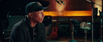 Movie still from “Popstar: Never Stop Never Stopping” (2016), directed by Akiva Schaffer – A man sitting in front of a guitar in a recording studio; Close Up shot, Over the shoulder angle