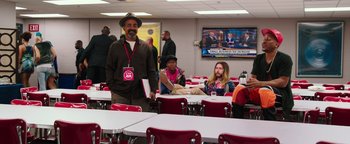Movie still from “Popstar: Never Stop Never Stopping” (2016), directed by Akiva Schaffer – A group of people sitting at tables in a room; Wide shot, High angle