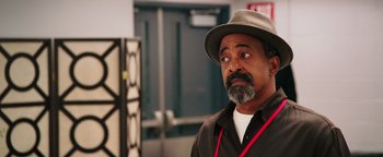 Movie still from “Popstar: Never Stop Never Stopping” (2016), directed by Akiva Schaffer – A man with a hat and a beard looking at the camera; Close Up shot, Over the shoulder angle