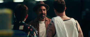 Movie still from “Popstar: Never Stop Never Stopping” (2016), directed by Akiva Schaffer – A man in a hat talking to two other people; Close Up shot, Over the shoulder angle