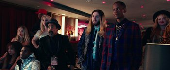 Movie still from “Popstar: Never Stop Never Stopping” (2016), directed by Akiva Schaffer – A group of men standing next to each other in a room; Medium shot, Low angle