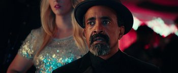 Movie still from “Popstar: Never Stop Never Stopping” (2016), directed by Akiva Schaffer – A man with a beard wearing a black hat; Close Up shot, Over the shoulder angle