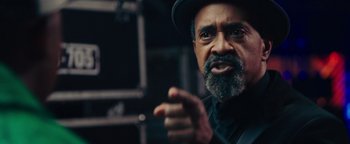 Movie still from “Popstar: Never Stop Never Stopping” (2016), directed by Akiva Schaffer – An older man with a beard wearing a hat; Close Up shot, Low angle