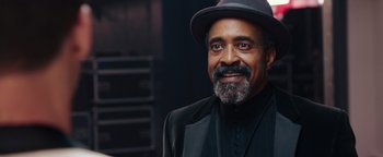 Movie still from “Popstar: Never Stop Never Stopping” (2016), directed by Akiva Schaffer – A man with a beard wearing a hat and a suit; Close Up shot, Low angle