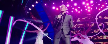 Movie still from “Popstar: Never Stop Never Stopping” (2016), directed by Akiva Schaffer – A man singing into a microphone on a stage; Medium shot, Low angle