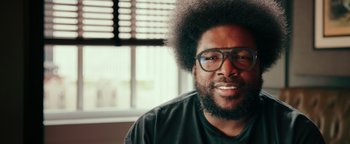 Movie still from “Popstar: Never Stop Never Stopping” (2016), directed by Akiva Schaffer – A person wearing glasses and a black shirt; Close Up shot, Low angle