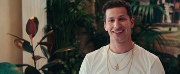 Movie still from “Popstar: Never Stop Never Stopping” (2016), directed by Akiva Schaffer – A man wearing a white t - shirt and a gold necklace; Close Up shot, Over the shoulder angle