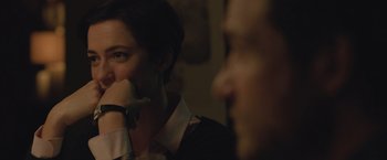 Movie still from “The Gift” (2015), directed by Joel Edgerton – A woman with her hand to her mouth and a man with his hand to her mouth; Close Up shot, Over the shoulder angle