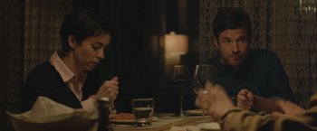 Movie still from “The Gift” (2015), directed by Joel Edgerton – A group of people sitting at a dinner table; Medium shot, Over the shoulder angle