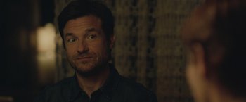 Movie still from “The Gift” (2015), directed by Joel Edgerton – A person wearing a black shirt; Close Up shot, Over the shoulder angle