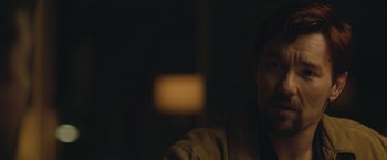 Movie still from “The Gift” (2015), directed by Joel Edgerton – A man sitting at a table in front of a window; Close Up shot, Over the shoulder angle