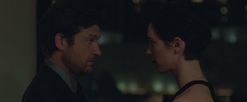Movie still from “The Gift” (2015), directed by Joel Edgerton – A man and a woman face to face in the dark; Close Up shot, Over the shoulder angle