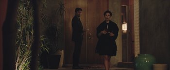 Movie still from “The Gift” (2015), directed by Joel Edgerton – A man and a woman standing next to each other in front of a door; Wide shot, Over the shoulder angle