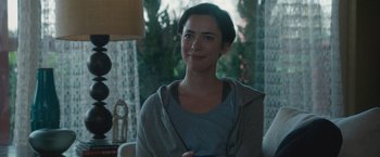 Movie still from “The Gift” (2015), directed by Joel Edgerton – A woman sitting in front of a window holding a cell phone; Close Up shot, Over the shoulder angle