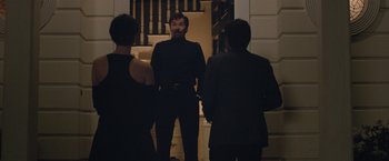 Movie still from “The Gift” (2015), directed by Joel Edgerton – A man standing next to two other people; Medium shot, Over the shoulder angle