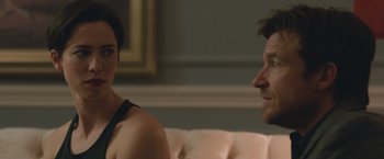Movie still from “The Gift” (2015), directed by Joel Edgerton – A man and a woman sitting on a white couch; Close Up shot, Over the shoulder angle