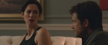 Movie still from “The Gift” (2015), directed by Joel Edgerton – A woman sitting next to a man on a couch; Close Up shot, Over the shoulder angle