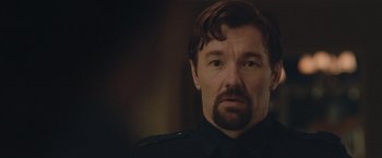Movie still from “The Gift” (2015), directed by Joel Edgerton – A person wearing a police uniform; Close Up shot, Over the shoulder angle