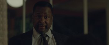 Movie still from “The Gift” (2015), directed by Joel Edgerton – A person wearing a suit and tie; Close Up shot, Over the shoulder angle