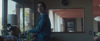 Movie still from “The Gift” (2015), directed by Joel Edgerton – A person standing in a room near a window; Medium shot, Over the shoulder angle