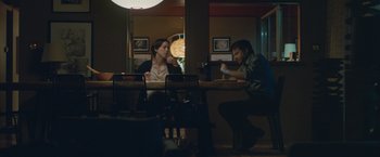 Movie still from “The Gift” (2015), directed by Joel Edgerton – A man and a woman are sitting at a table; Wide shot, Over the shoulder angle